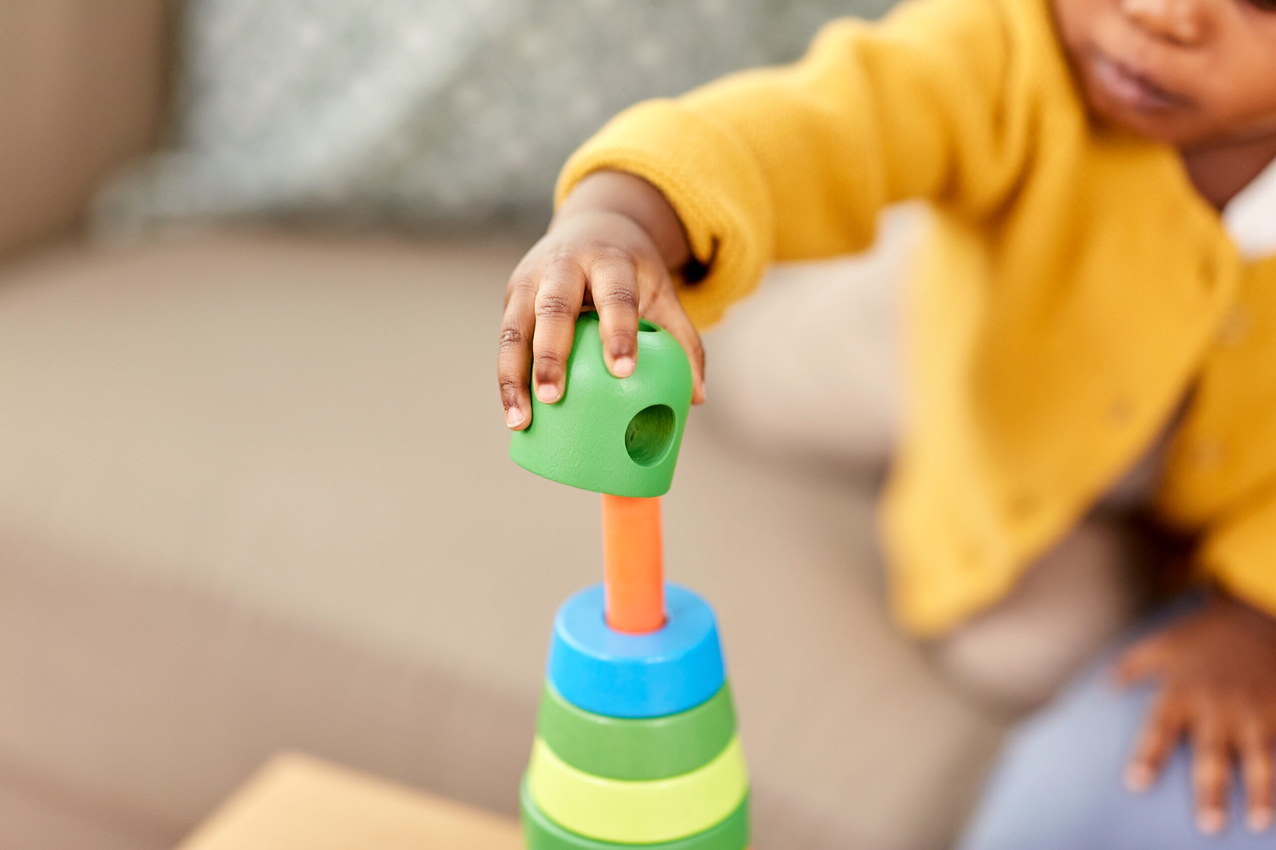 close up of african baby playing toy blocks child reading a book